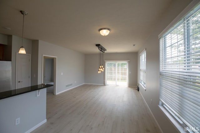 unfurnished living room with light wood-type flooring