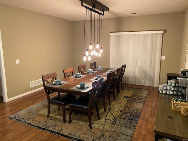 dining space featuring dark wood-type flooring