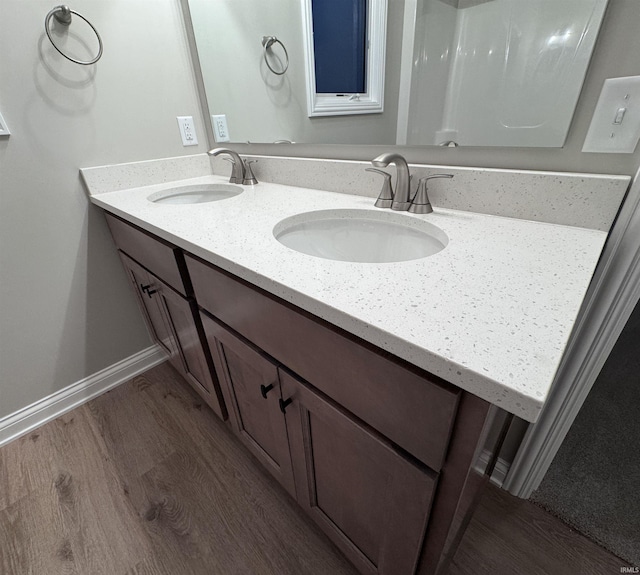 bathroom featuring hardwood / wood-style flooring and vanity