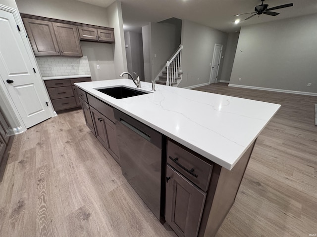 kitchen with ceiling fan, dishwasher, sink, tasteful backsplash, and light wood-type flooring