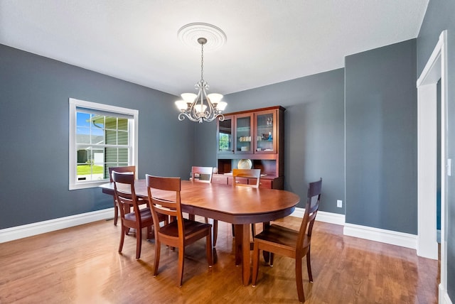 dining room with a chandelier and hardwood / wood-style floors