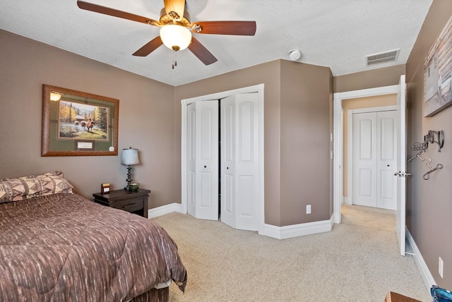 bedroom featuring light carpet and ceiling fan