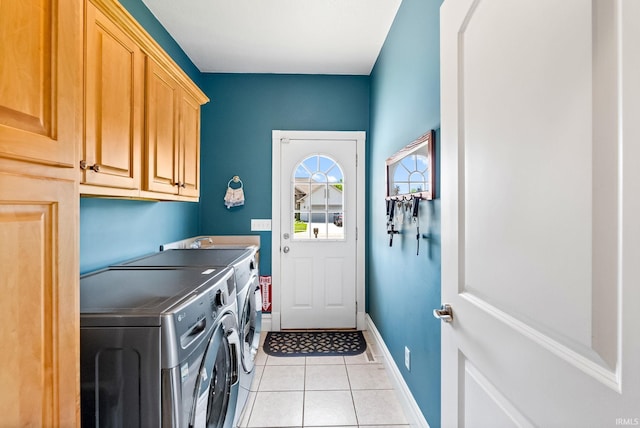 laundry room featuring light tile patterned flooring, washer and dryer, sink, and cabinets