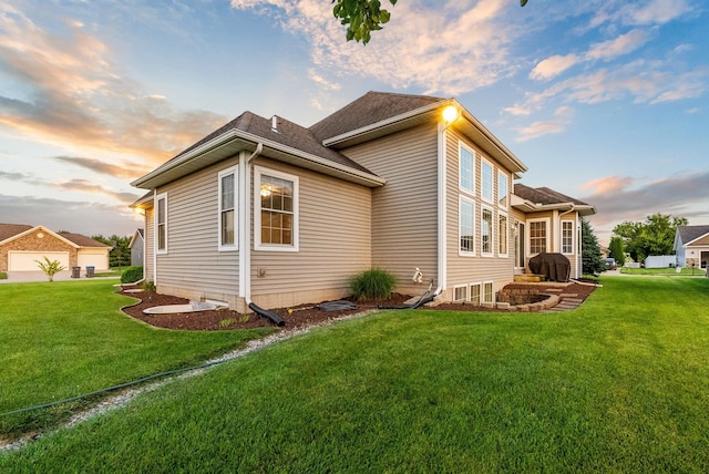 property exterior at dusk featuring a yard