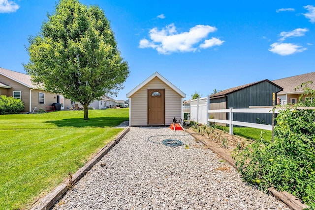 view of outbuilding featuring a yard