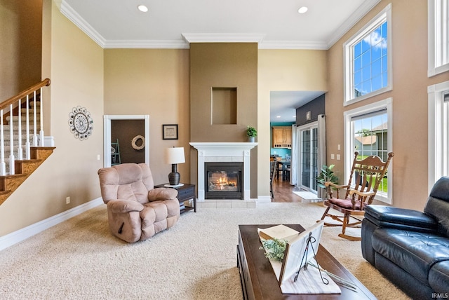 carpeted living room featuring a tile fireplace and crown molding