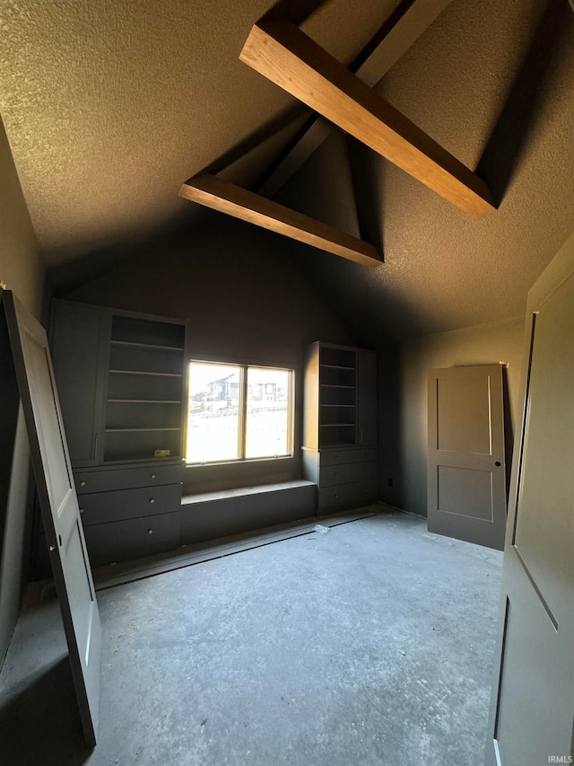 unfurnished bedroom featuring lofted ceiling and a textured ceiling