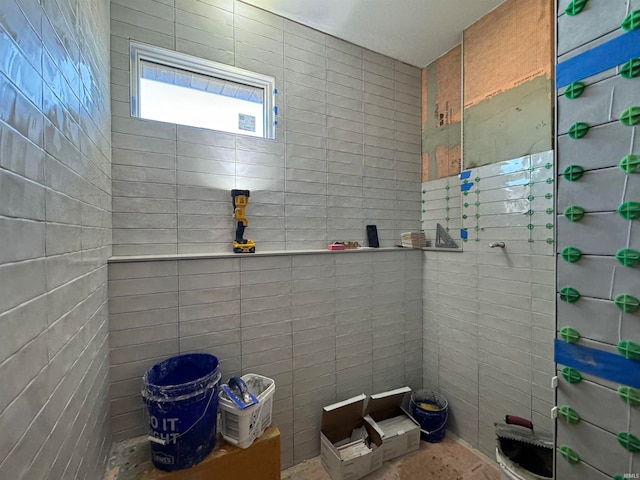 bathroom with tile walls