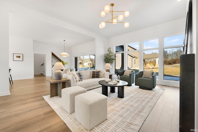 living room featuring an inviting chandelier and light hardwood / wood-style flooring