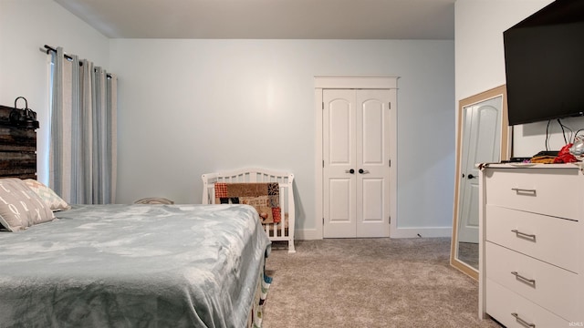 carpeted bedroom featuring a closet