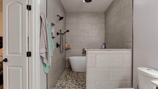 full bathroom featuring vanity, shower with separate bathtub, tile walls, and toilet