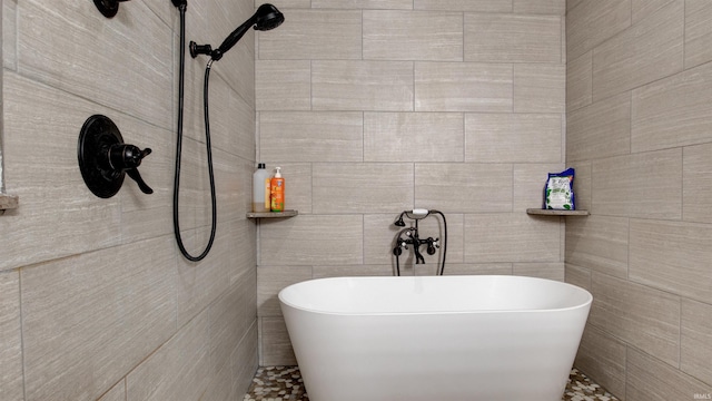 bathroom featuring a bathing tub and tile walls