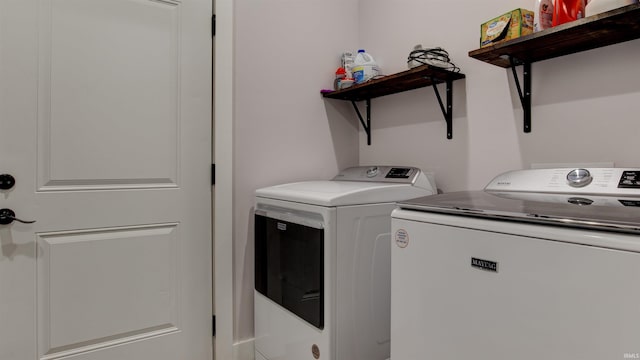 washroom with washing machine and clothes dryer