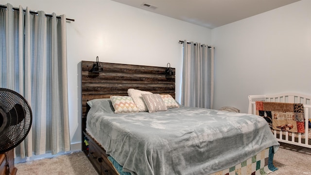 bedroom featuring light colored carpet