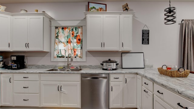 kitchen with light stone counters, white cabinets, decorative light fixtures, stainless steel dishwasher, and sink