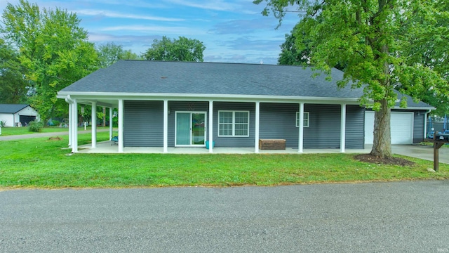 view of front of property with a garage and a front lawn