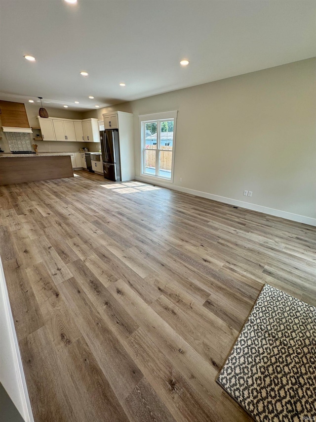 unfurnished living room featuring light hardwood / wood-style flooring