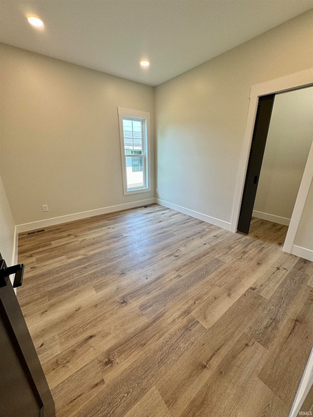 unfurnished room featuring light hardwood / wood-style flooring