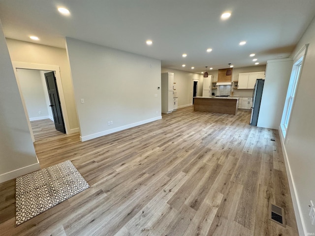 unfurnished living room with light hardwood / wood-style flooring