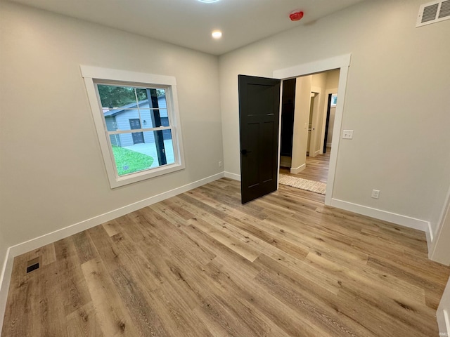 unfurnished bedroom with light wood-type flooring