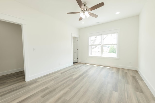 spare room featuring ceiling fan and light wood-type flooring