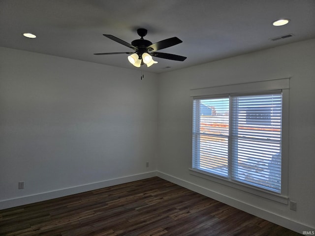 spare room with dark hardwood / wood-style floors and ceiling fan