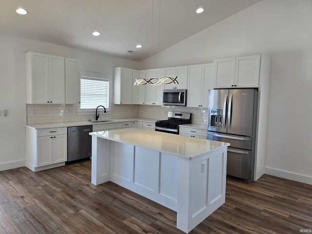 kitchen with stainless steel appliances, a center island, sink, and white cabinets