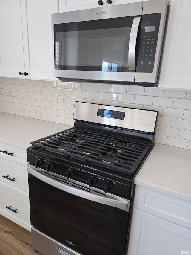 interior details featuring stainless steel appliances and white cabinets