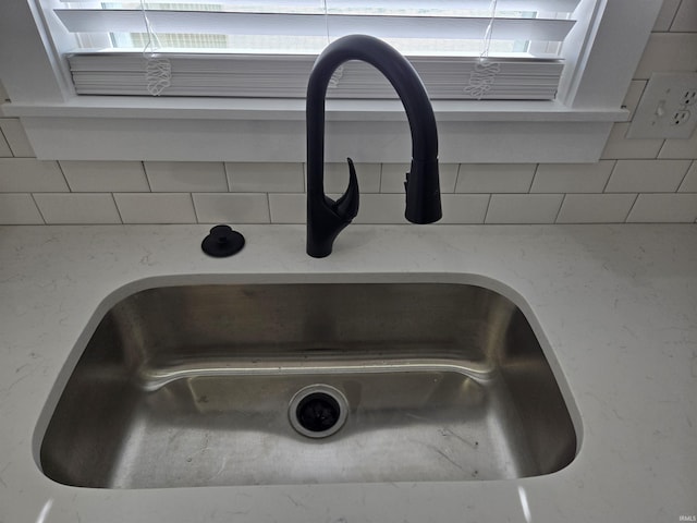 interior details featuring tasteful backsplash and sink