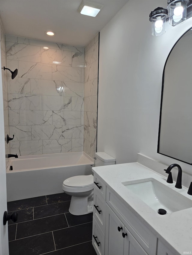 full bathroom with vanity, tile patterned flooring, tiled shower / bath combo, and toilet