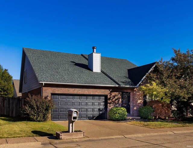 view of front of home featuring a garage and a yard