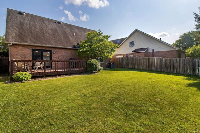 view of yard with central AC and a wooden deck