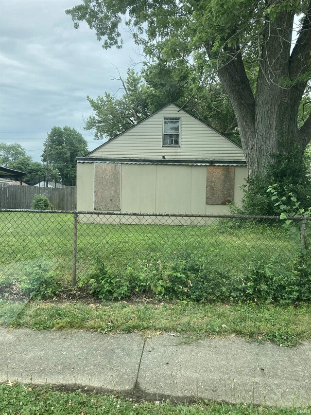 view of property exterior with a lawn