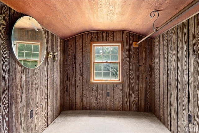 spare room featuring wood walls, wooden ceiling, and lofted ceiling