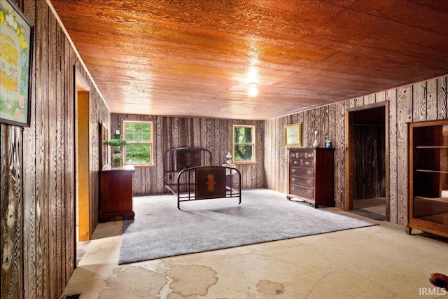 unfurnished living room with wooden walls and wooden ceiling