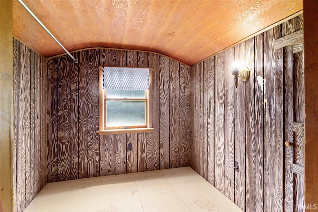 unfurnished room featuring lofted ceiling