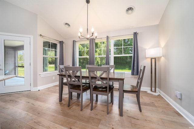 dining space featuring lofted ceiling, a notable chandelier, and light hardwood / wood-style floors