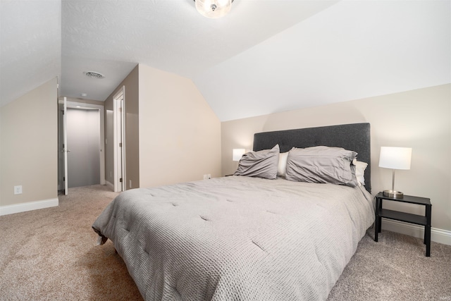 bedroom featuring lofted ceiling and light carpet