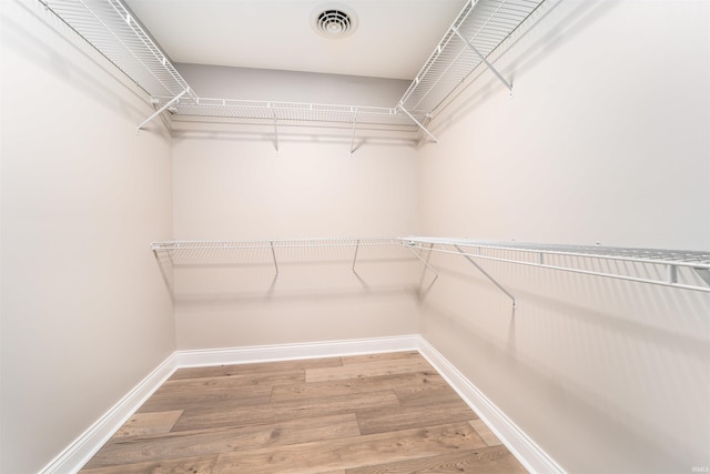 spacious closet featuring hardwood / wood-style flooring