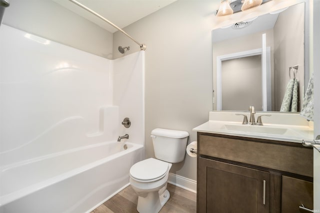 full bathroom with shower / bath combination, vanity, hardwood / wood-style floors, and toilet