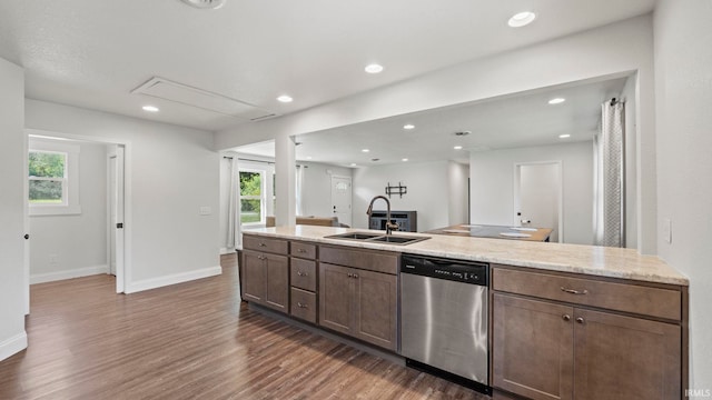 kitchen with sink, dark wood-type flooring, dishwasher, dark brown cabinets, and light stone countertops