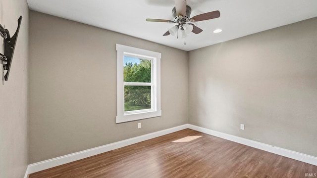 spare room with hardwood / wood-style flooring and ceiling fan