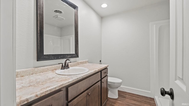 bathroom featuring hardwood / wood-style flooring, vanity, and toilet