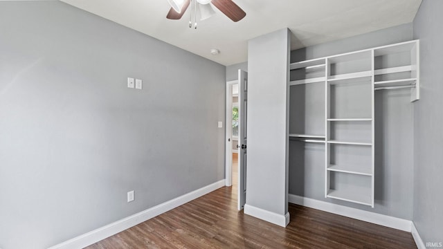 unfurnished bedroom featuring dark wood-type flooring, a closet, and ceiling fan