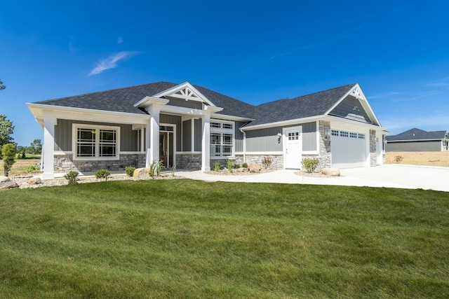 craftsman-style house featuring a garage and a front lawn