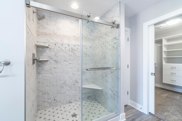 bathroom featuring hardwood / wood-style flooring and a shower with door