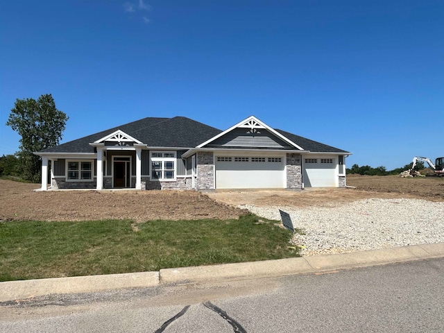 craftsman-style house with a front yard and a garage