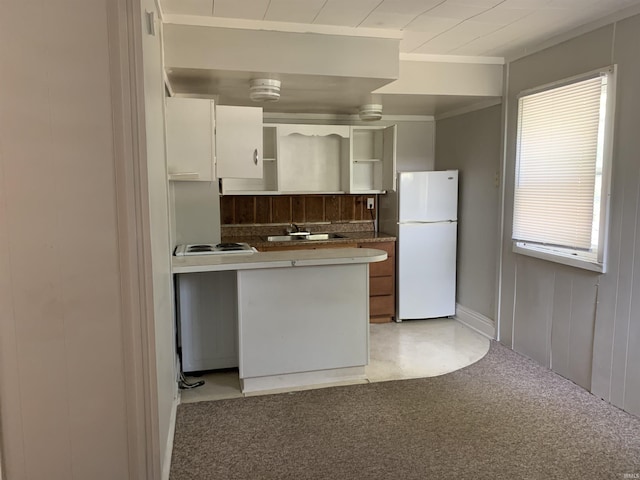 kitchen featuring sink, white cabinetry, crown molding, light carpet, and white appliances