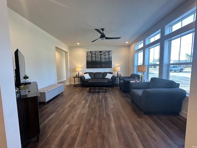 living area with a textured ceiling, a ceiling fan, dark wood-type flooring, and recessed lighting