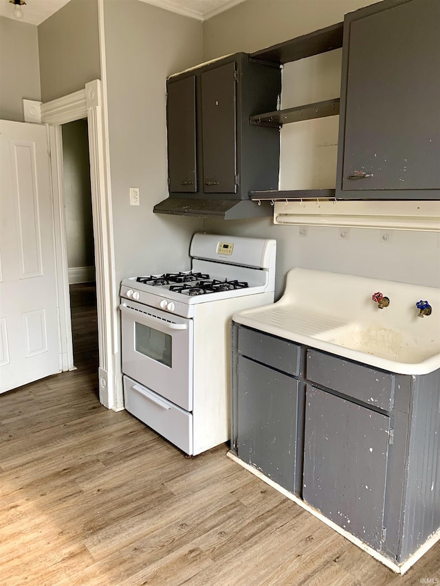 kitchen featuring light hardwood / wood-style flooring and white range with gas stovetop